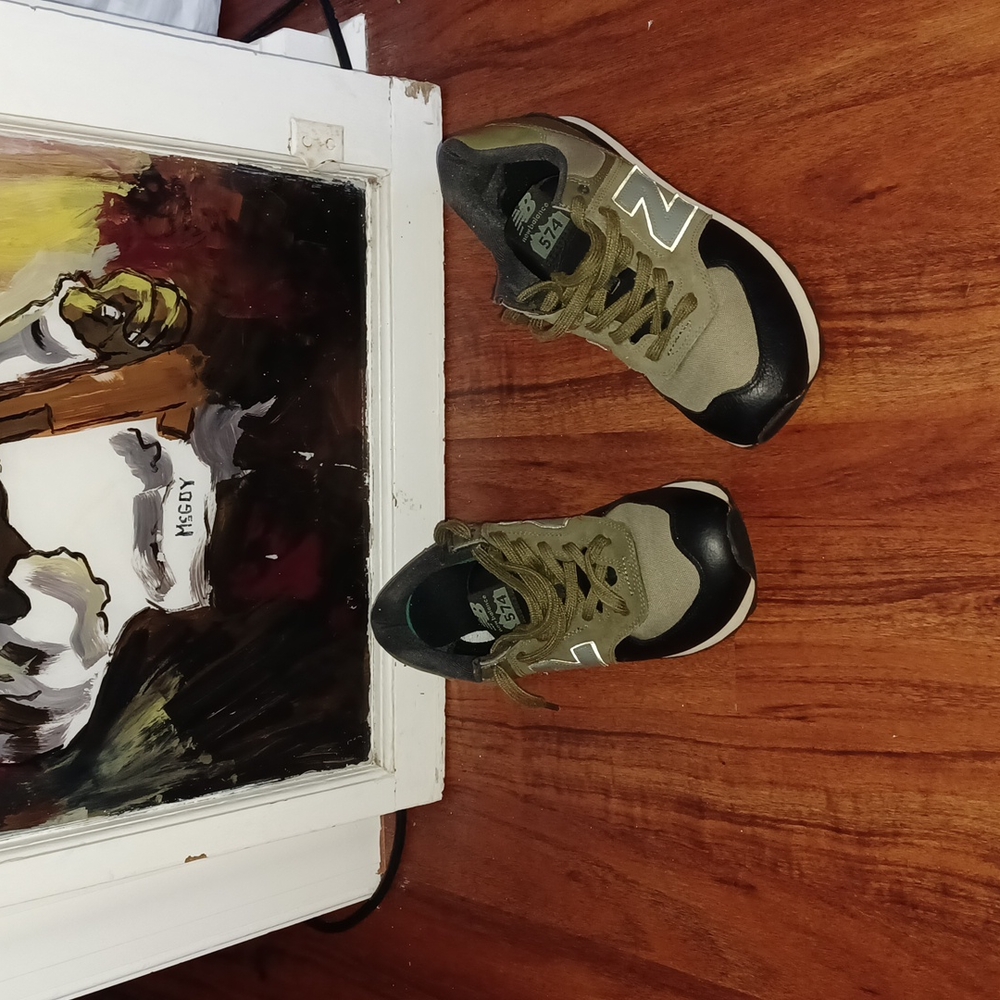 New Balance 574's  size 10.5. Olive green and black sneakers.